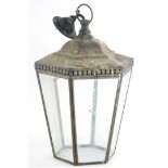 A dark patinated brass lantern, with tapering bevelled glass to the hexagonal pierced top, 28cm