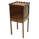 A 19thC mahogany pot cupboard, with a raised gallery above a panelled door and a drawer, on tapering