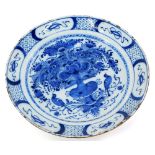 An 18thC English Delft plate, decorated with a basket of flowers, birds, etc., in blue within