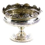 A George V silver rose bowl, the top cast with scrolls, etc., Chester 1910, loaded, 11cm high.