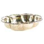 A George V silver bowl, with a shaped edge, cast with scrolls, Chester 1912, makers stamp