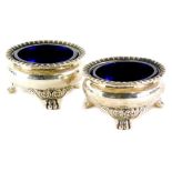 A pair of George III silver salts, each with a gadrooned border on paw feet, headed by scrolls,