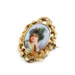 A late 19thC portrait memorial brooch, the oval portrait depicting a boy in feathered hat, in rococo