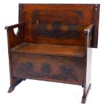 An early 20thC carved oak monks bench, with a rectangular top with a moulded edge, on pierced end