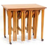 An unusual nest of 1960/70s teak tables, comprising a rectangular table on turned tapering legs with
