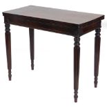 A George IV rosewood card table, the hinged rectangular top with rounded corners, above a panel