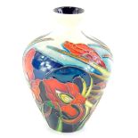 A Moorcroft pottery vase, decorated with a band of iris', on a blue and cream ground, 10cm high.