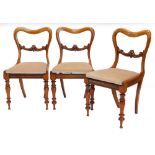 A set of three Victorian mahogany balloon back dining chairs, each with a drop in seat on turned