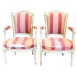 A pair of early 20thC fauteuil, each painted in cream and green in the manner of Colefax and Fowler,
