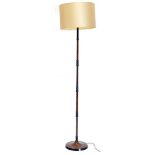 A slender metal standard lamp, painted to simulate wood on a circular base, 173cm high overall.