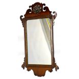 A George III mahogany fret frame wall mirror, with a pierced dark gilt shell to the crest and parcel