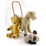 Three plush toys, to include a Tri-ang type push-a-long terrier, a Harrods bear and a Sweep puppet.