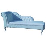 A cream leatherette upholstered chaise lounge, with button back and arm, on cabriole legs, 156cm