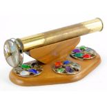 An unusual brass and wooden kaleidoscope, with five coloured and stained glass roundels, 23cm long.
