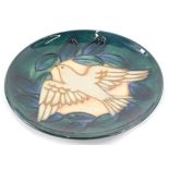 A Moorcroft pottery limited edition plaque, decorated with a dove of peace, on a turquoise ground,