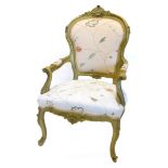 A continental painted fauteuil, carved with shells, flowers, etc. upholstered in patterned crewel