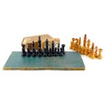 A Staunton pattern yew and ebonised chess set, a chess board and a timer clock.