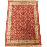 A Kashmir rug, with an all over meandering design of scrolls, flowerheads, leaves, etc., one wide