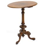 A Victorian walnut occasional table, the oval top on a carved turned column and tripod base, 71cm