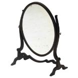 A mahogany dressing table mirror, with an oval plate on shaped supports.