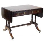 A George IV mahogany and rosewood crossbanded sofa table, the rectangular top with a gadrooned