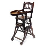 A late 19thC child's metamorphic walnut highchair, on end supports with turned stretchers and