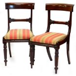 A pair of 19thC mahogany dining chairs, each with a bar back, drop in seat on turned and fluted