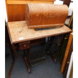 An oak treadle sewng machine with drawers etc.,