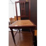 An Edwardian mahogany bedroom chair, with a cane seat.