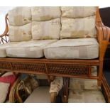 A cane three seater sofa and three matching chairs.