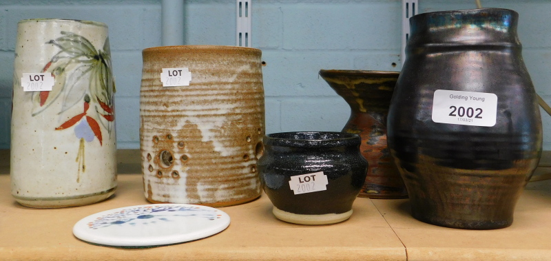A collection of studio pottery, to include a vase decorated with leaves, flowers, etc., on a green