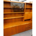 A Macintosh teak room unit with drawers, cupboard doors and sliding doors etc.