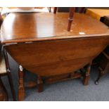 An oak oval drop leaf table.