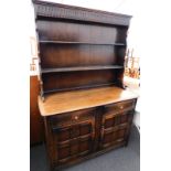 An Ercol type oak dresser, with two tier plate rack, two drawers and two panel doors.