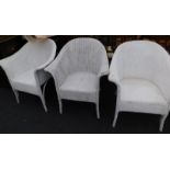 Three white painted Lloyd Loom type chairs.