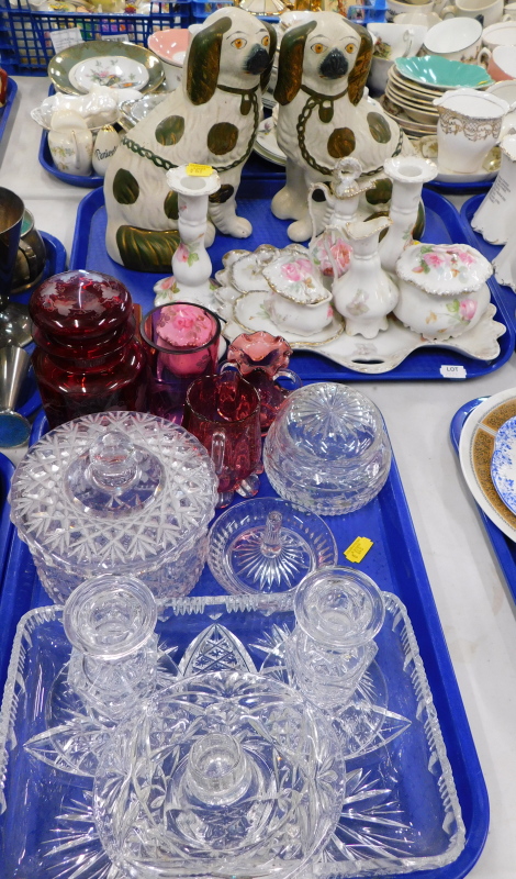 A pair of Staffordshire style spaniels, Limoges style part dressing table set, cranberry ware, a