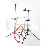 A Crivit Sports bicycle repair stand, FN-1290., a bike tree, and a bike rack. (3)