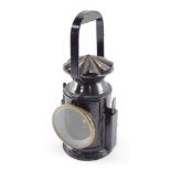 A WWII C. Eastgate & Son Ltd military issue railway lamp, black painted with oval plaque C. Eastgate