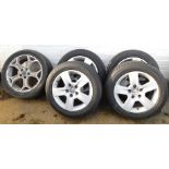 Four Audi A4 alloy wheels with hubcaps, and assorted tyres, and a Ford Mondeo wheel with hubcap