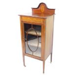 An Edwardian mahogany and inlaid display cabinet, the domed back with paterae inlay, over a glazed d