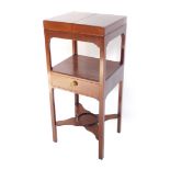 A George III mahogany washstand, with folding top and frieze drawer, raised on square legs united by