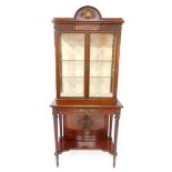 A late 19thC Louis XVI style mahogany vitrine, with metal mounts, the domed pediment cast centrally