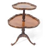 A Georgian style mahogany two tier dumb waiter, the graduated trefoil tiers with pierced and carved