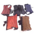 Five heavy steel boned training corsets, size 26, to fit 28-32 inch waist, comprising black taffeta,