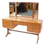 A G plan teak dressing table, with a tryptic mirror back, over a central fitted jewellery drawer, fl