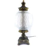 A Continental 20thC brass table lamp, with a clear cut glass shade and brass cap, 63cm high.