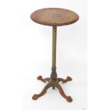 A Victorian pub table, the circular mahogany top raised on a brass spiral fluted column and cast iro