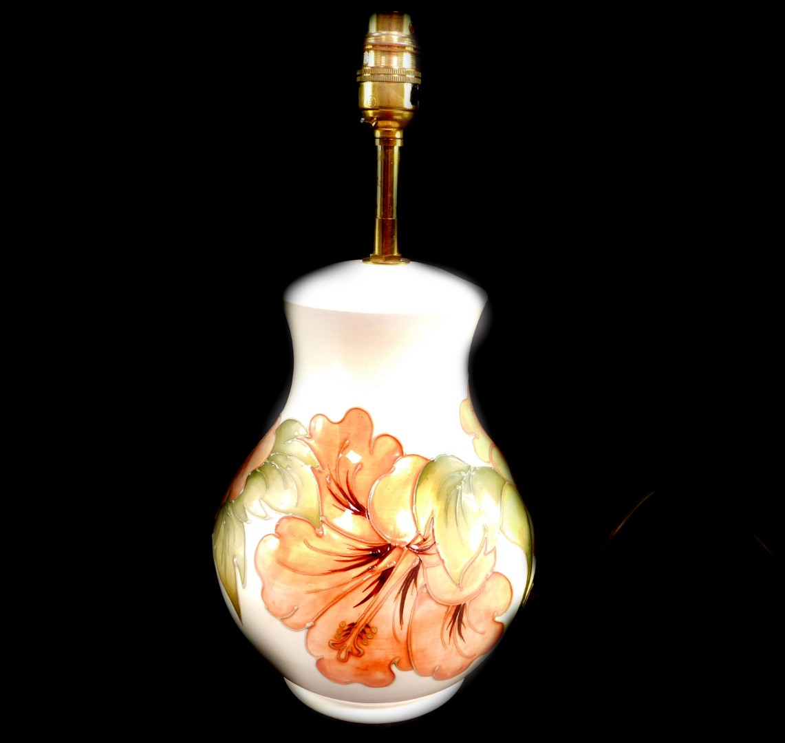 A Moorcroft pottery table lamp decorated in the Hibiscus pattern, of ginger jar and cover form, agai