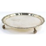A silver piecrust salver, the gadrooned rim embossed with Celtic beasts, raised on four scroll feet,
