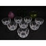 A set of eight cut glass fruit bowls, pair of engraved green glass footed vases, further green vase